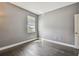 Sunny bedroom featuring wood floors, fresh paint, and ample natural light at 1314 Oak Pond St, Ruskin, FL 33570