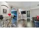 Contemporary dining area featuring a glass table with sleek seating, next to the entertainment area at 1314 Oak Pond St, Ruskin, FL 33570