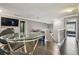Modern dining area with glass table and chairs, offering access to upstairs and a separate room at 1314 Oak Pond St, Ruskin, FL 33570