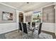 Dining room with modern crystal chandelier, neutral walls, and seating for six at 1314 Oak Pond St, Ruskin, FL 33570