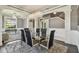 Elegant dining area with a glass table, chandelier lighting, and stylish decor at 1314 Oak Pond St, Ruskin, FL 33570