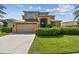 A two-story home with mature palm trees and landscaping at 1314 Oak Pond St, Ruskin, FL 33570