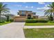 Charming two-story home with lush landscaping, driveway, and a two-car garage at 1314 Oak Pond St, Ruskin, FL 33570