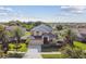 Beautiful two-story home featuring a well-manicured lawn and a black metal roof at 1314 Oak Pond St, Ruskin, FL 33570