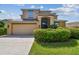 A two-story home with a well manicured front yard featuring beautiful shrubbery at 1314 Oak Pond St, Ruskin, FL 33570