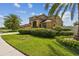 This beautiful home is surrounded by lush landscaping and has a well-maintained lawn at 1314 Oak Pond St, Ruskin, FL 33570