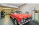Clean garage featuring a red vintage vehicle with additional space for other recreational vehicles at 1314 Oak Pond St, Ruskin, FL 33570