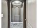 Hallway showcasing elegant arches and stone flooring, creating a seamless transition to the next space at 1314 Oak Pond St, Ruskin, FL 33570