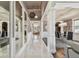 Hallway with marble tile floors, high ceilings, and open sightlines to dining room and living room at 1314 Oak Pond St, Ruskin, FL 33570