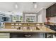 Close up of kitchen island sink with granite counters, and living room view at 1314 Oak Pond St, Ruskin, FL 33570