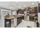 Spacious kitchen with dark cabinetry, stainless steel appliances, and stone countertops at 1314 Oak Pond St, Ruskin, FL 33570