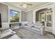 Living room featuring crown molding, gray walls, and gray leather seating area at 1314 Oak Pond St, Ruskin, FL 33570