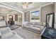 Living room featuring crown molding, gray walls, and gray leather seating area at 1314 Oak Pond St, Ruskin, FL 33570