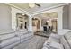 Open concept living room featuring crown molding, gray walls, and gray leather seating area at 1314 Oak Pond St, Ruskin, FL 33570