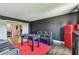 Cozy living room with plush seating, stylish red mini-fridge, and a foosball table for recreation at 1314 Oak Pond St, Ruskin, FL 33570
