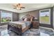 Main bedroom featuring a wooden bed frame, views from the windows, and dark walls at 1314 Oak Pond St, Ruskin, FL 33570