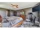 The main bedroom features a wooden bed frame, exercise bike, and dark walls at 1314 Oak Pond St, Ruskin, FL 33570