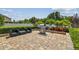 Brick patio with an outdoor kitchen featuring a stainless steel grill and ample space for entertaining guests at 1314 Oak Pond St, Ruskin, FL 33570