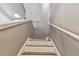 View up the stairs with wood and marble treads and white risers at 1314 Oak Pond St, Ruskin, FL 33570
