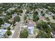 High aerial shot with a blue border showing the house, driveway, and nearby roads at 1410 Nebraska Ave, Palm Harbor, FL 34683