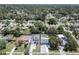 Aerial view of property with a blue border showing the house, driveway, and nearby homes at 1410 Nebraska Ave, Palm Harbor, FL 34683