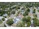 High aerial shot with a blue border showing the house, driveway, and nearby homes at 1410 Nebraska Ave, Palm Harbor, FL 34683