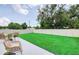 Fenced backyard featuring new sod, a patio, and outdoor seating at 1410 Nebraska Ave, Palm Harbor, FL 34683