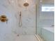 Contemporary shower featuring marble tile and modern rainfall shower head and fixtures at 1410 Nebraska Ave, Palm Harbor, FL 34683