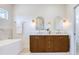 Beautiful bathroom boasting a double vanity with gold fixtures and modern design at 1410 Nebraska Ave, Palm Harbor, FL 34683