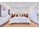 Bright bedroom featuring modern decor, with the bathroom visible through an open doorway at 1410 Nebraska Ave, Palm Harbor, FL 34683