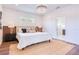 Inviting bedroom with modern lighting, soft textures, and a glimpse into the adjoining bathroom at 1410 Nebraska Ave, Palm Harbor, FL 34683