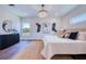 Stylish bedroom showcasing hardwood floors, contemporary decor, and a serene ambiance with natural light at 1410 Nebraska Ave, Palm Harbor, FL 34683