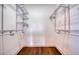 Empty closet with wood floor, shelving and metal racks ready for storage at 1410 Nebraska Ave, Palm Harbor, FL 34683