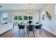 Bright dining area with sleek lighting, hardwood floors, and views of the backyard at 1410 Nebraska Ave, Palm Harbor, FL 34683