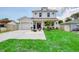 Charming two-story home with a manicured lawn and cozy outdoor seating area in front at 1410 Nebraska Ave, Palm Harbor, FL 34683