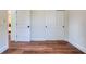 Hallway with wood flooring, white trim, and doors to the bedrooms and closets at 1410 Nebraska Ave, Palm Harbor, FL 34683