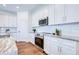 Well-lit kitchen features white cabinets, stainless appliances, and granite countertops at 1410 Nebraska Ave, Palm Harbor, FL 34683