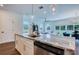 Modern open-concept kitchen with stainless steel appliances and a beautiful island at 1410 Nebraska Ave, Palm Harbor, FL 34683