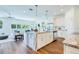 Open-concept kitchen with a large island, marble countertops, white cabinets, stainless steel appliances, and pendant lighting at 1410 Nebraska Ave, Palm Harbor, FL 34683