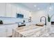 Close up of a modern kitchen island with stainless steel appliances, stylish countertops and white cabinets at 1410 Nebraska Ave, Palm Harbor, FL 34683