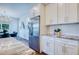 Kitchen with stainless steel appliances, white cabinets, and view to dining area at 1410 Nebraska Ave, Palm Harbor, FL 34683