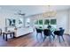 Open living and dining area with hardwood floors and contemporary furniture at 1410 Nebraska Ave, Palm Harbor, FL 34683