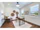 Bright home office featuring neutral walls, wood floors, stylish decor, and natural light from two windows at 1410 Nebraska Ave, Palm Harbor, FL 34683