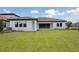 Exterior backyard view of a home showcasing a well-maintained lawn and patio area at 14279 Swiss Bridge Dr, Riverview, FL 33579
