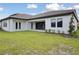 A spacious backyard features a well-maintained lawn and a covered patio, excellent for relaxing and entertaining at 14279 Swiss Bridge Dr, Riverview, FL 33579