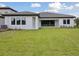 Expansive backyard features a lush lawn and a covered patio, perfect for outdoor entertaining at 14279 Swiss Bridge Dr, Riverview, FL 33579