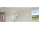 A bright, neutrally decorated bedroom featuring large windows, tray ceiling and plush carpet at 14279 Swiss Bridge Dr, Riverview, FL 33579