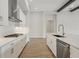 Modern kitchen featuring white cabinets, stainless steel appliances, and light wood flooring at 14279 Swiss Bridge Dr, Riverview, FL 33579