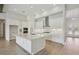 Bright kitchen with white cabinets, a large island, and modern stainless steel appliances at 14279 Swiss Bridge Dr, Riverview, FL 33579