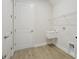 Functional laundry room with utility sink and wire shelving at 14279 Swiss Bridge Dr, Riverview, FL 33579